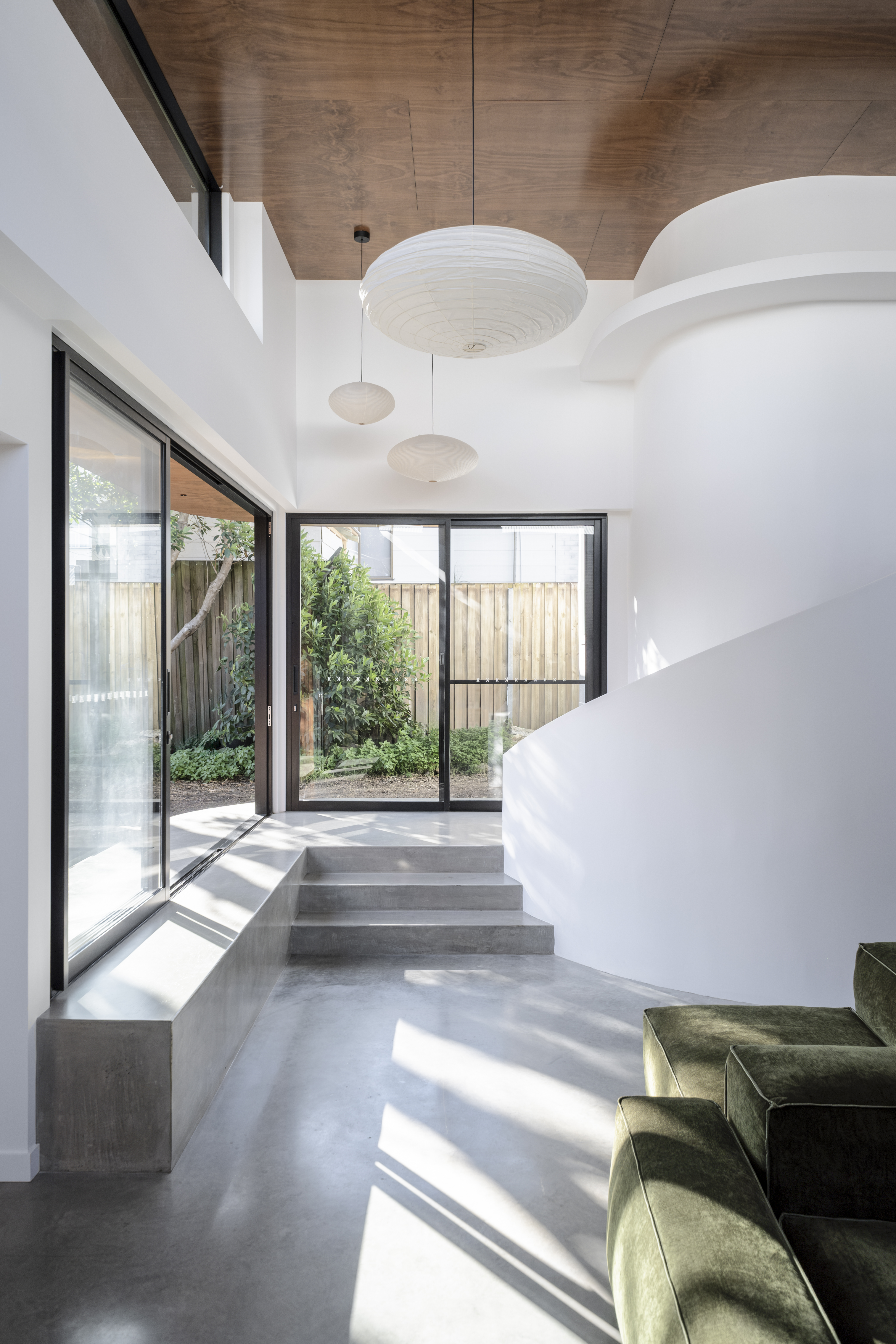 Art House interior — curved white walls, plywood ceiling and polished concrete with natural light